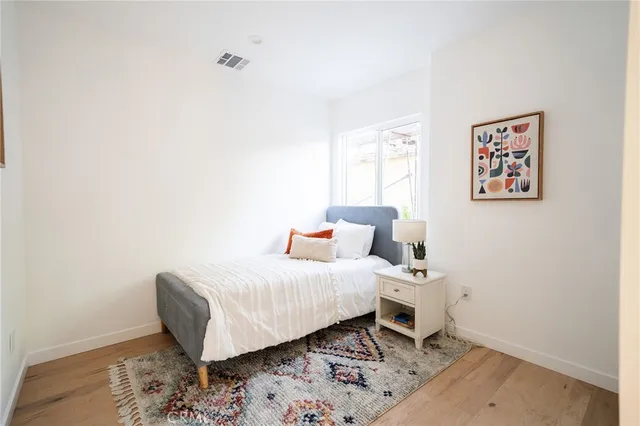 a bedroom with a bed and a window