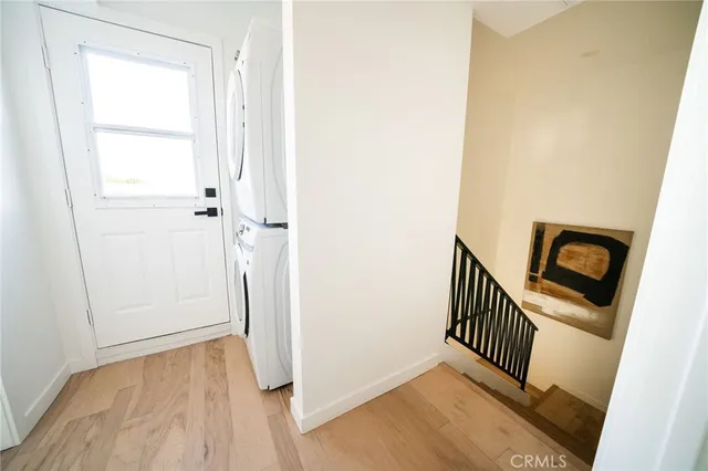 an empty room with wooden floor and a door