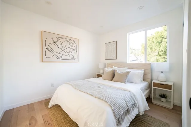 a bedroom with a bed and a painting on the wall