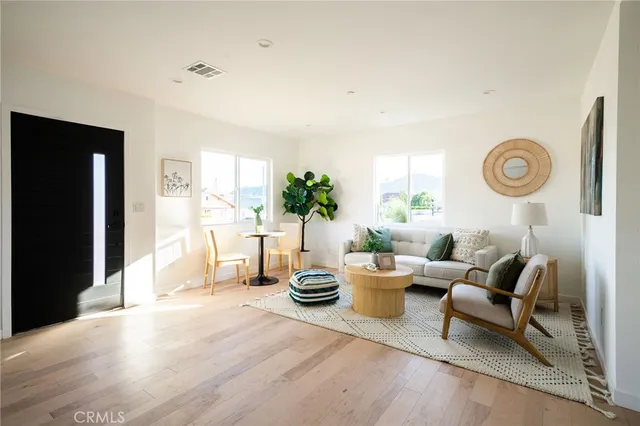 a living room with furniture a clock and a window