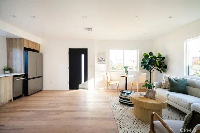 a living room with furniture and kitchen view