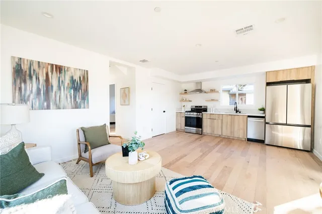 a living room with furniture and kitchen view