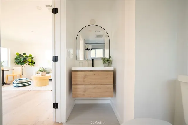 a view of living room with a sink and a mirror