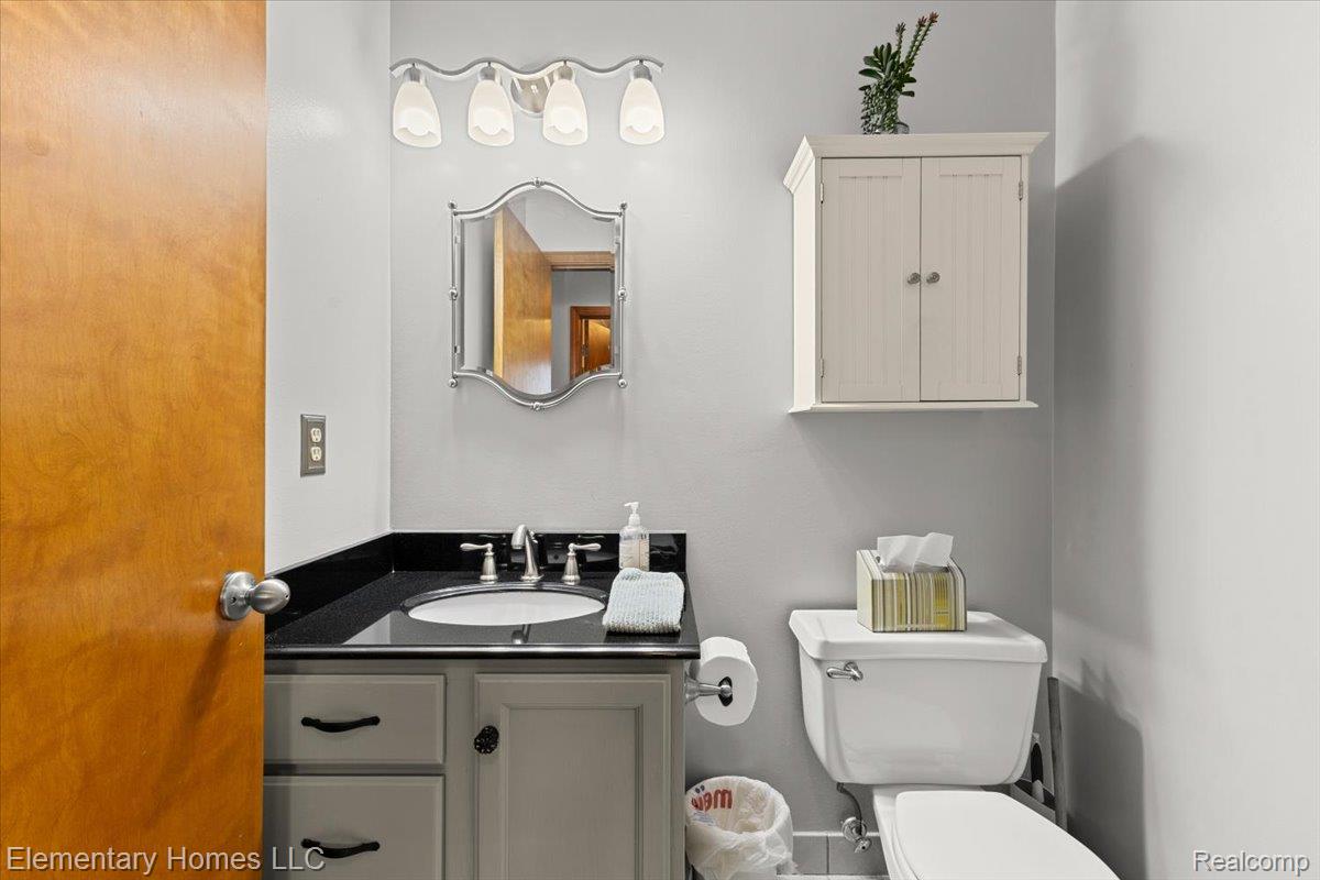 51637 Baker Road New Baltimore, MI 48047 - Photo 13 of 47 Half bathroom with vanity and toilet