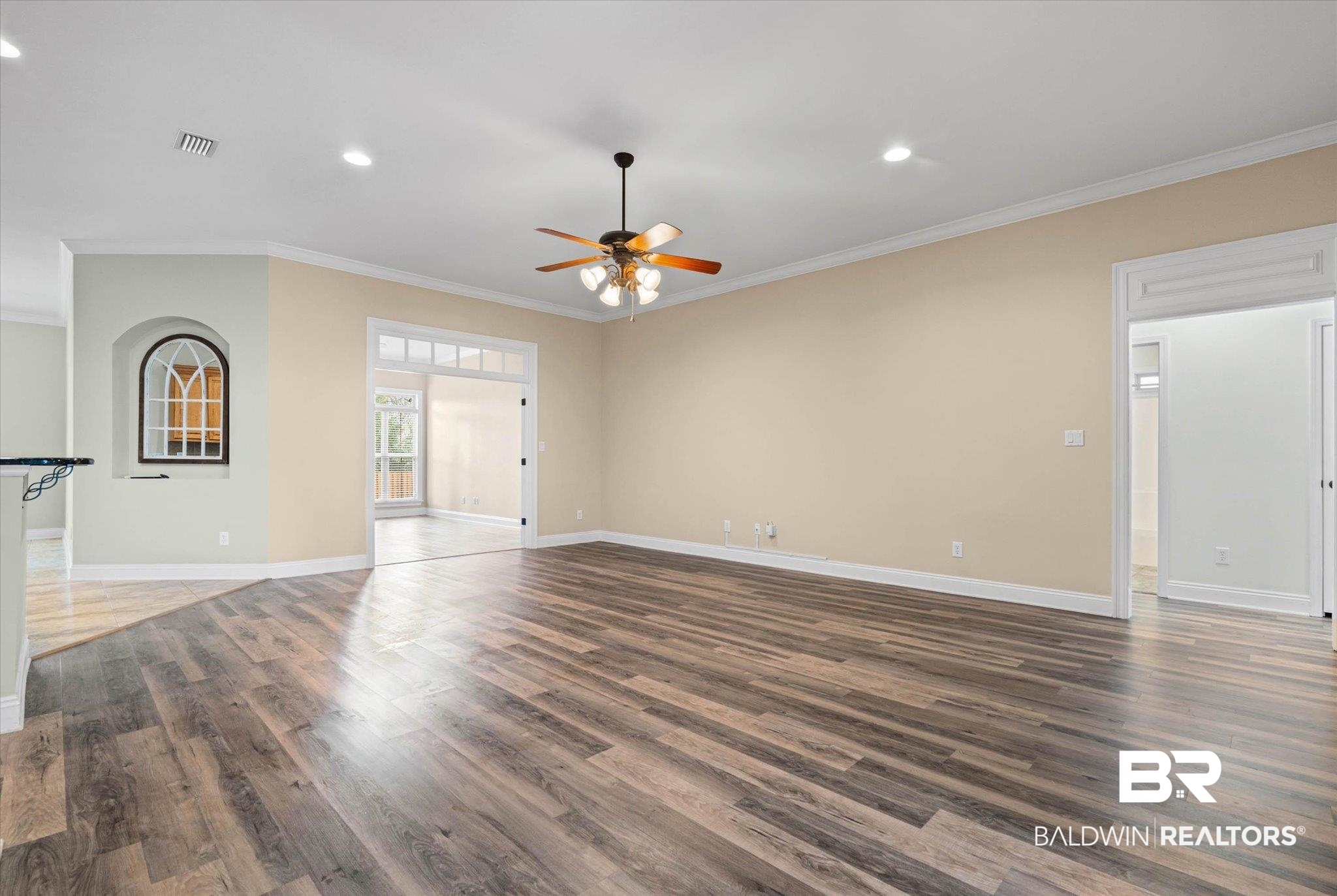 704 Edinburgh Avenue Foley, AL 36535 - Photo 5 of 32 Unfurnished living room featuring recessed lighting, dark wood-style flooring, ornamental molding, and ceiling fan