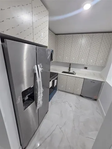 a kitchen with stainless steel appliances a refrigerator and a sink