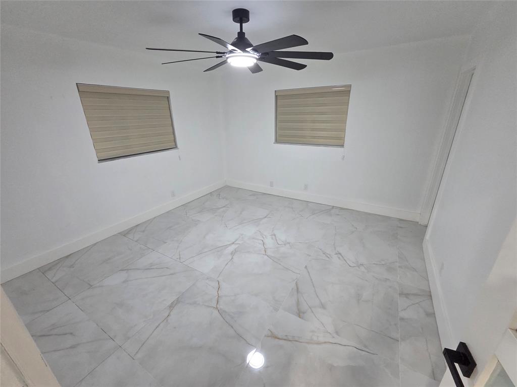 251 South Cypress Road, Unit 101 Pompano Beach, FL 33060 - Photo 16 of 41 a view of an empty room with a window