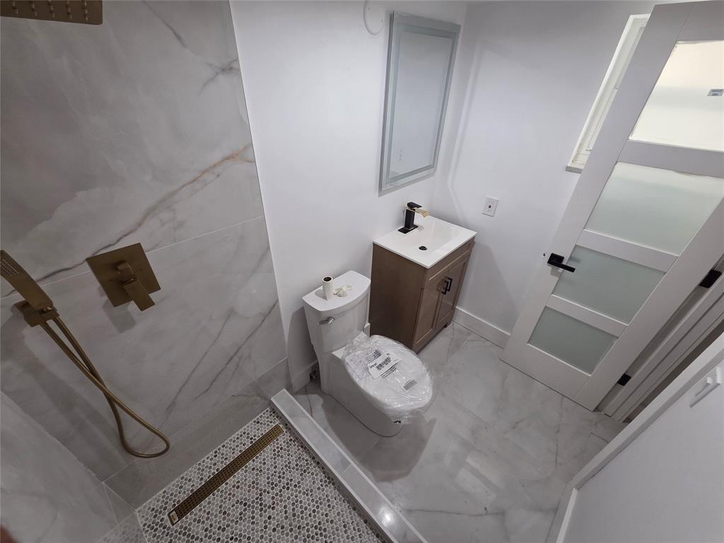 251 South Cypress Road, Unit 101 Pompano Beach, FL 33060 - Photo 27 of 41 a bathroom with a sink and toilet