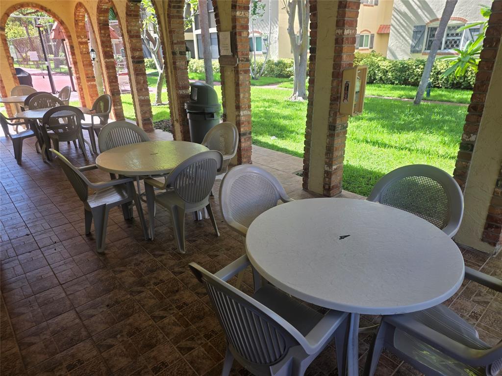 251 South Cypress Road, Unit 101 Pompano Beach, FL 33060 - Photo 40 of 41 a view of a dining room with furniture window and outside view