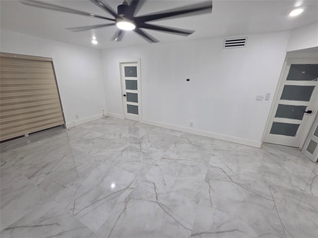 251 South Cypress Road, Unit 101 Pompano Beach, FL 33060 - Photo 6 of 41 wooden floor in an empty room with a window