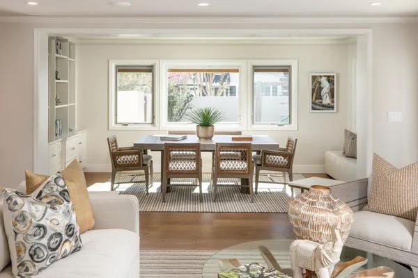 a dining room with furniture and wooden floor