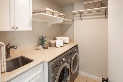 a kitchen with a sink and a washer dryer