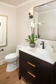 a bathroom with a sink a toilet and mirror