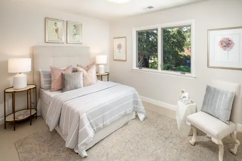 a bedroom with a bed and a large window