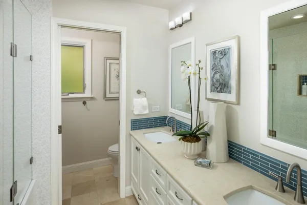 a bathroom with a sink a toilet and mirror