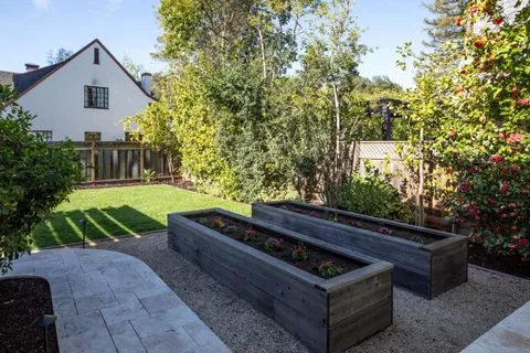a backyard of a house with chairs and a fire pit