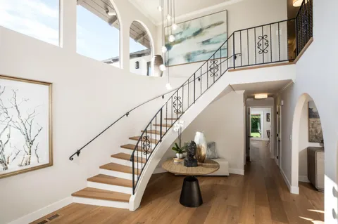 a view of entryway and hall with wooden floor