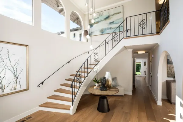 a view of entryway and hall with wooden floor