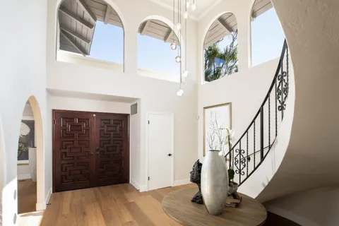 a view of an entryway with wooden floor