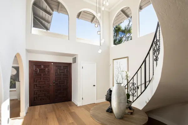 a view of an entryway with wooden floor