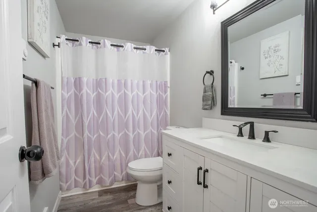 a bathroom with a sink a toilet and a mirror