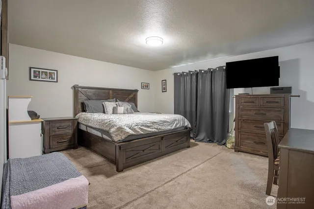 a bedroom with a bed and a television