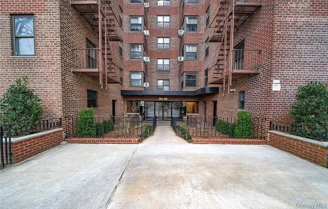 a view of a brick building with a porch