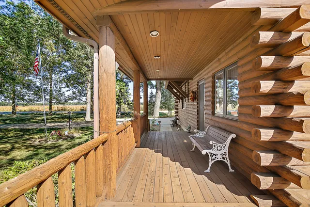 a view of a balcony with chairs and wooden floor