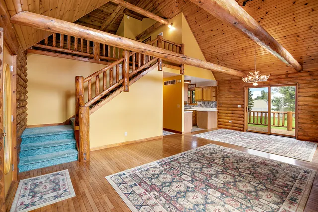 a view of a living room and kitchen with a sink