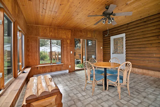 a view of a house with a big yard and large trees