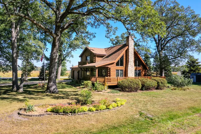 a front view of a house with a yard covered with snow