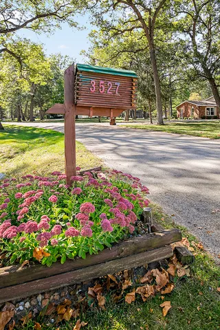 a sign that is in front of flowers