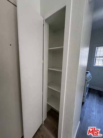 a area with a wooden floor and a hallway