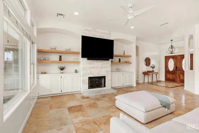 a living room with fireplace furniture and a flat screen tv