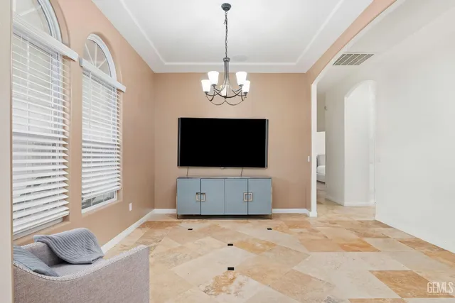 a living room with a flat screen tv and a window