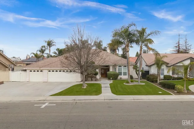 a view of a street with palm trees