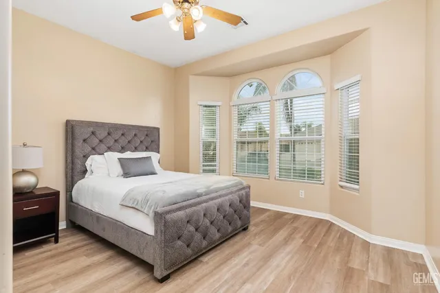 a bedroom with a large bed and a large window