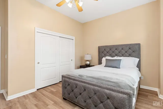 a bedroom with a bed and a painting on the wall