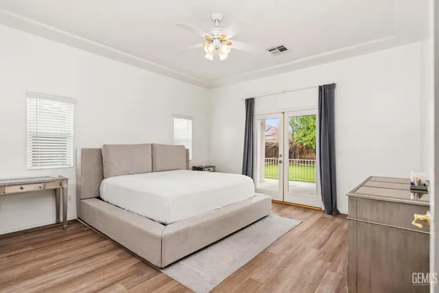 a spacious bedroom with a bed and a window