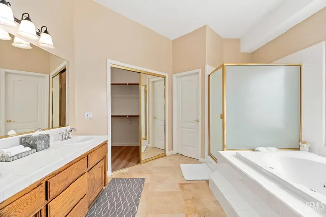 a spacious bathroom with a tub sink and mirror