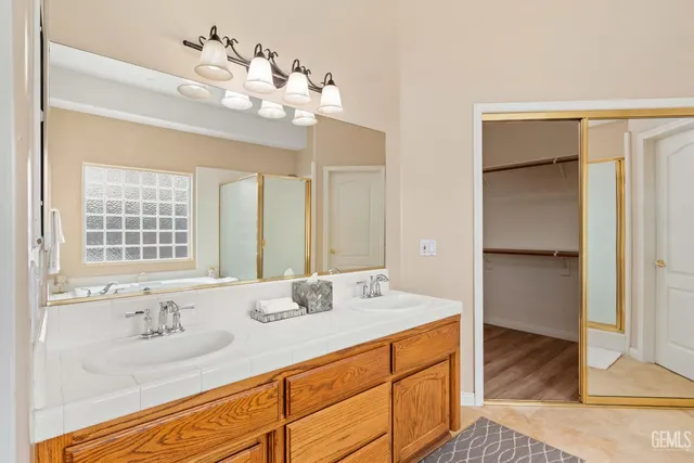 a bathroom with a sink double vanity and a mirror