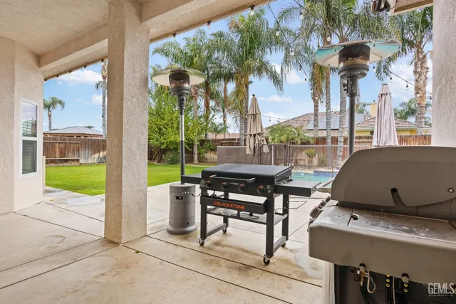 a view of a patio with table and chairs and potted plants