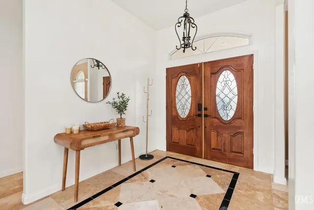 a bathroom with a table a mirror and a clock on the wall