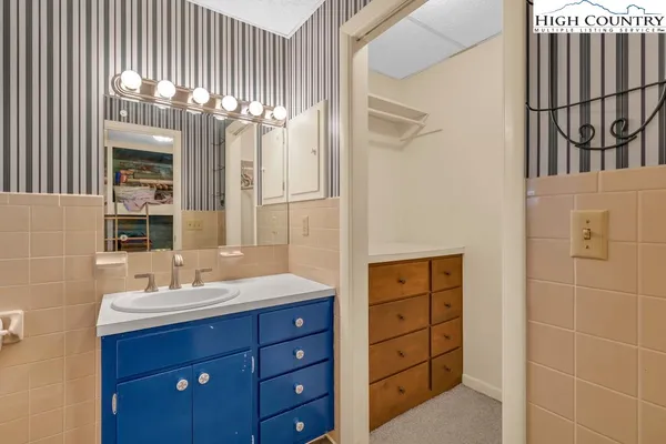 a bathroom with a double vanity sink a mirror and a shower