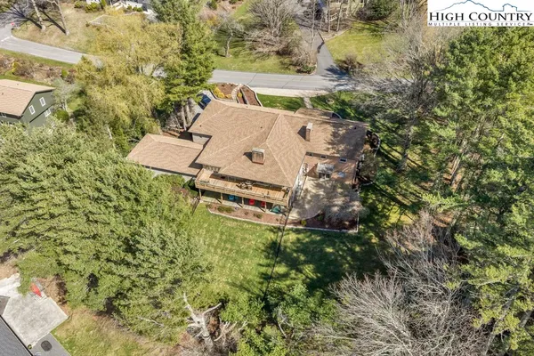 an aerial view of a house with a yard