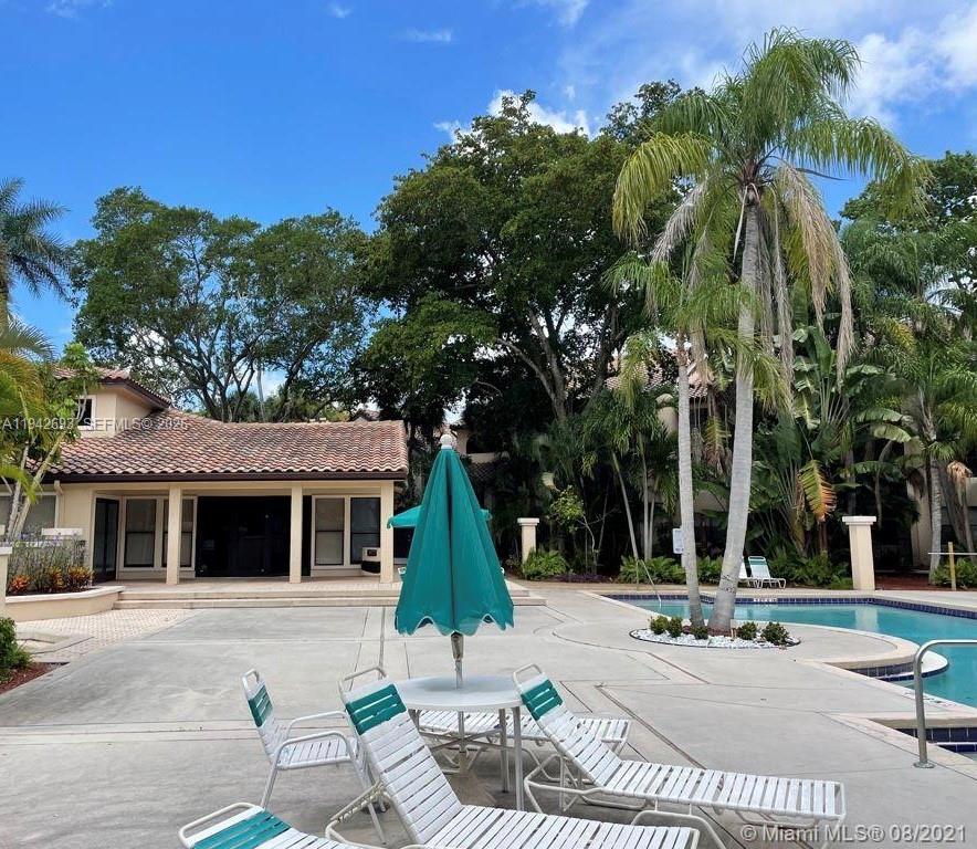 4421 West McNab Road, Unit 20 Pompano Beach, FL 33069 - Photo 14 of 14 a view of a white house with a yard and plants