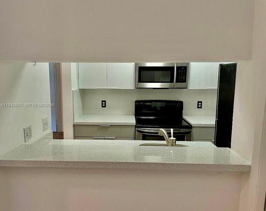 4421 West McNab Road, Unit 20 Pompano Beach, FL 33069 - Photo 7 of 14 a living room with stainless steel appliances kitchen island granite countertop a sink and a stove top oven