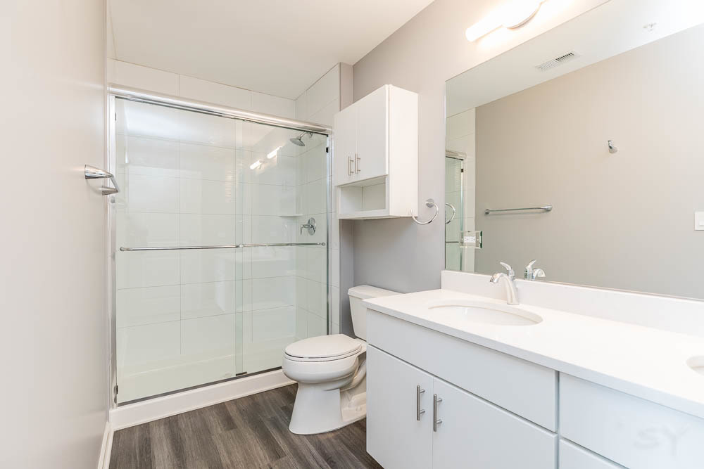 1312 Shermer Road, Unit 301 Northbrook, IL 60062 - Photo 7 of 10 a bathroom with a sink a toilet and shower