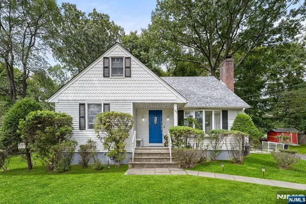 a front view of a house with a yard and porch
