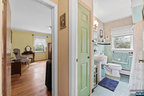a view of a bedroom with furniture and wooden floor